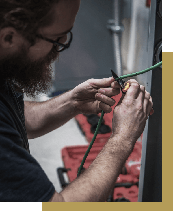 Electrician cutting an electrical cable